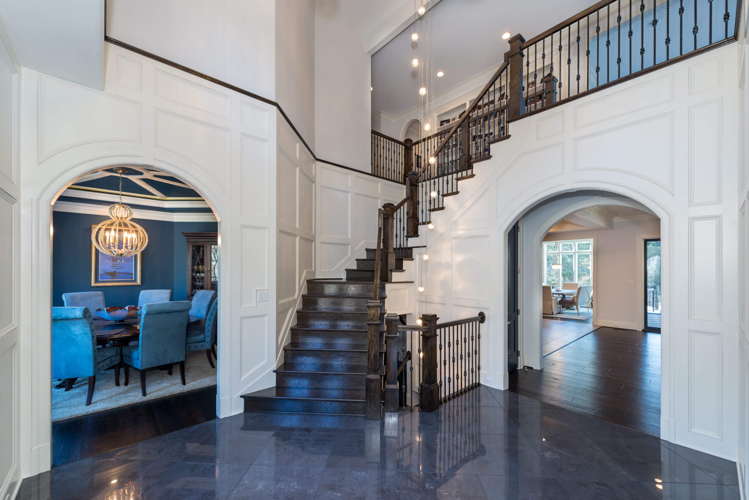 Hallway with grand staircase of a home