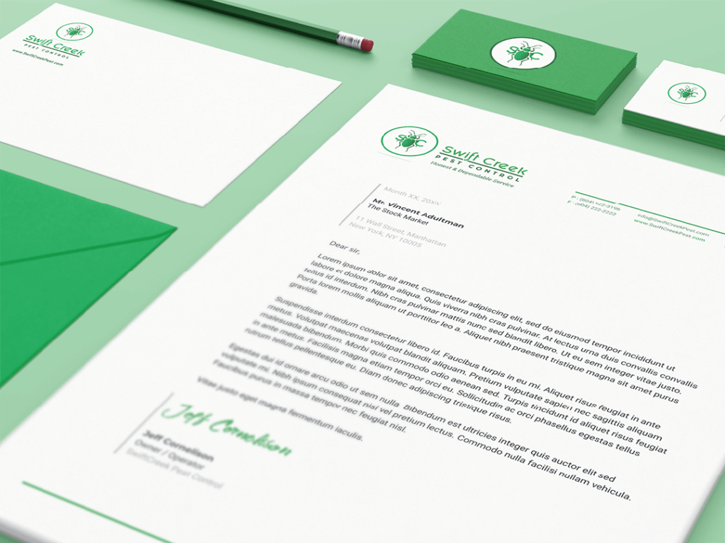 Mockup of print design assets on a green table featuring a letterhead, business card, letter, and pencil design